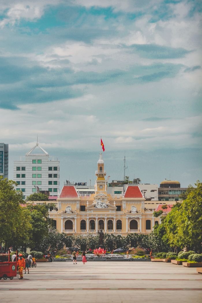 A vibrant cityscape featuring the iconic People's Committee Building in Ho Chi Minh City, Vietnam.